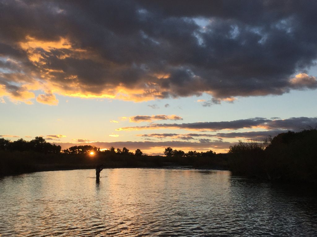 River water reflecting a cloudy Montana sunset